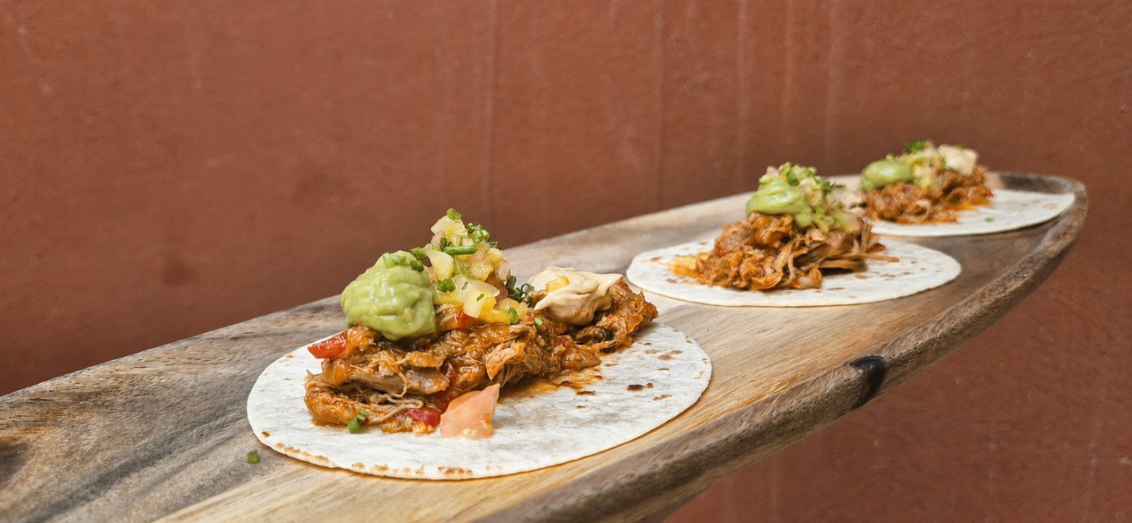 Tres tacos de Ternasco de Aragón al pastor con guacamole, pico de gallo y tortilla de trigo.